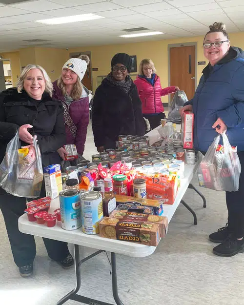 Micro Pantry Volunteers spend time donating to local micro pantry food boxes.