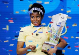 Zaila Avent Inernational Spelling Bee competition winner holding trophy.