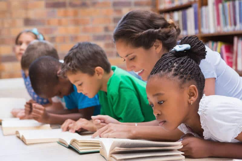 children reading with mentor
