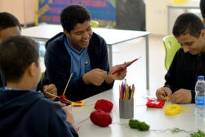 Students with special needs in classroom, working and laughing