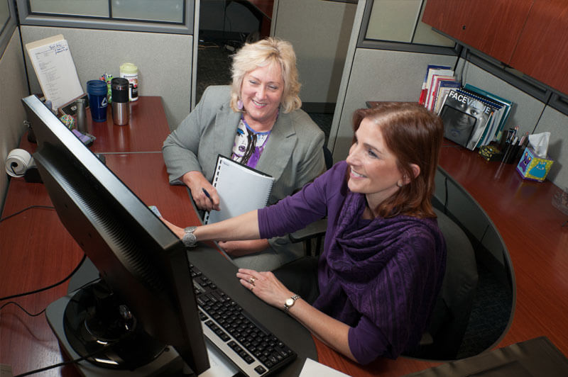 women at computer desk